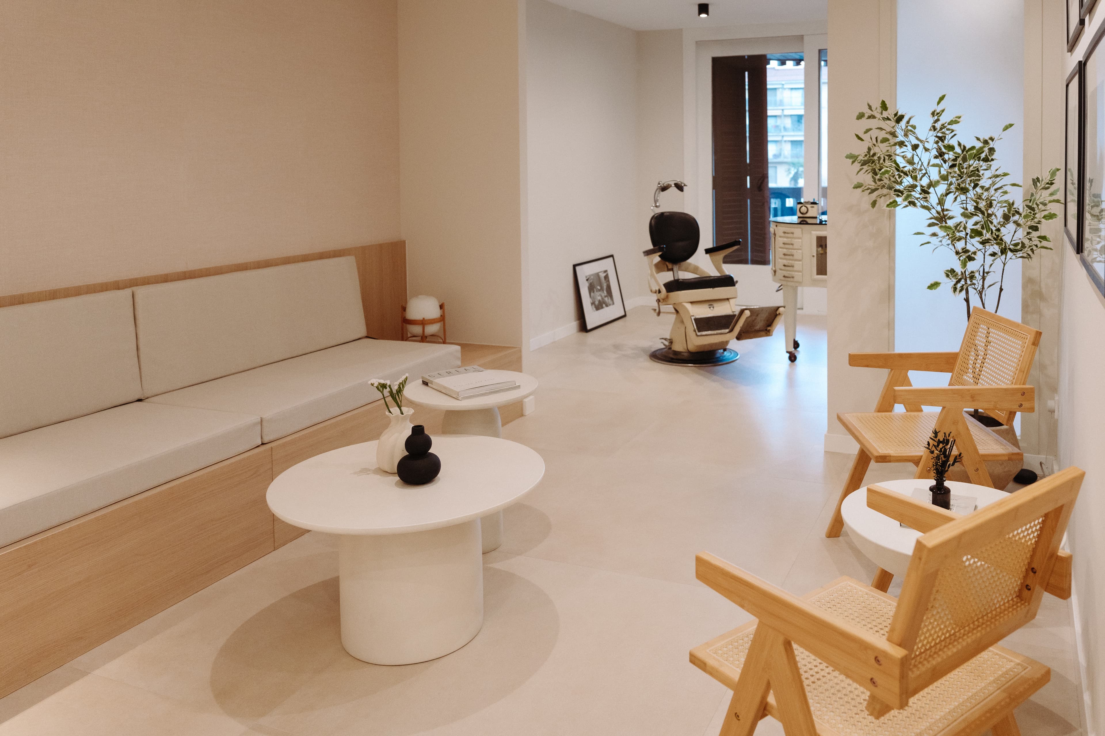 Vista de la sala de espera desde el mostrador, viendo las sillas, el banco y las mesitas